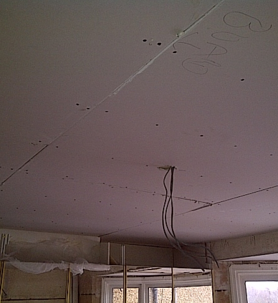 New plasterboard fixed to ceiling
